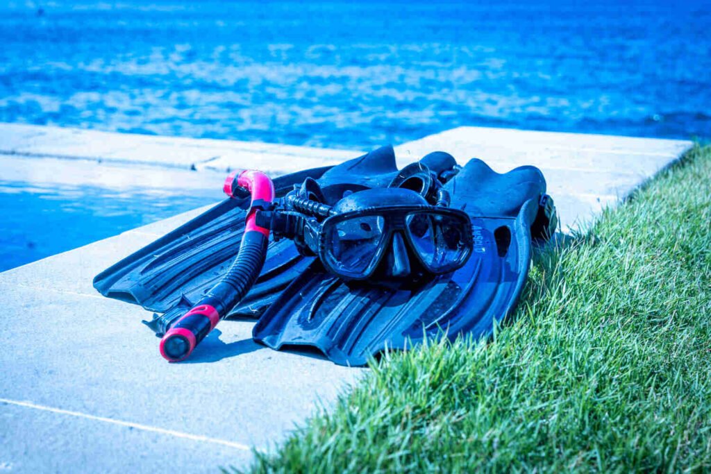 Snorkelling mask, snorkel and fins resting on the pool edge at Villa Seaview Bukti, ready for a swim off the North Bali coast