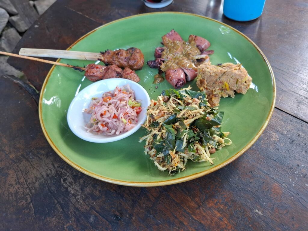 Bali Kuno tasting plate at Dapur Bali Mula: sate, squid in green spice paste, tum and urab with shredded coconut