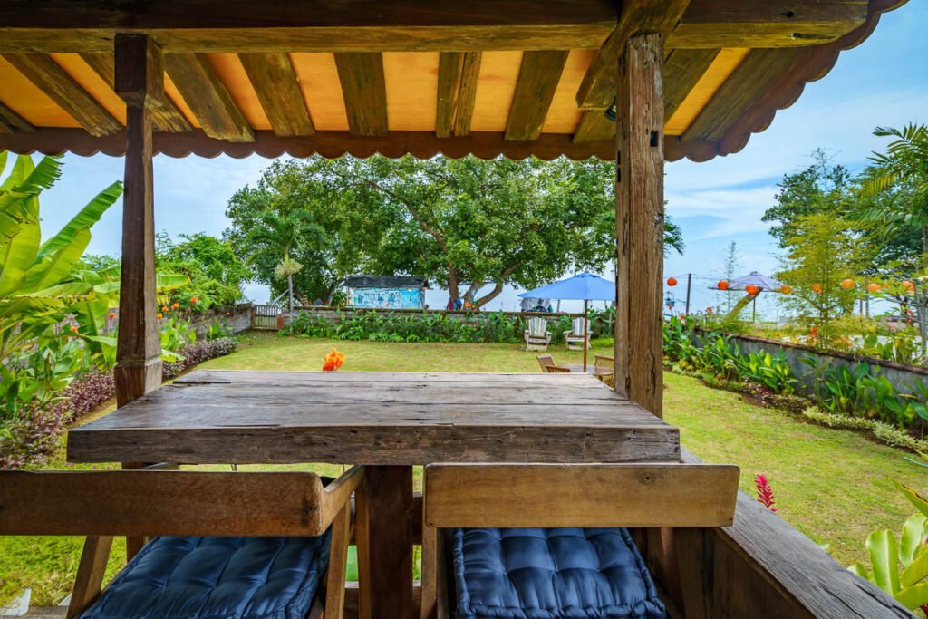 One long teak table in a garden bale by the sea, the setting for a private north Bali food and cooking evening